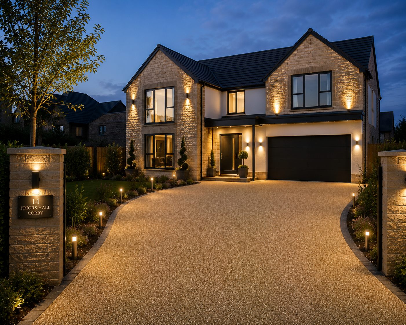 Golden resin bound driveway lit at dusk at a stone home in Priors Hall, Corby